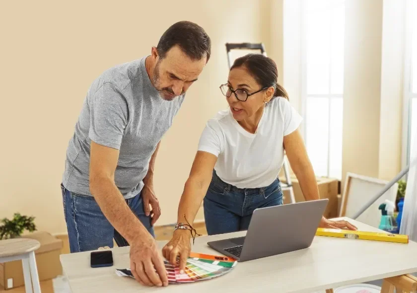 Teachers homeowners reviewing paint swatches for upcoming home improvement project.